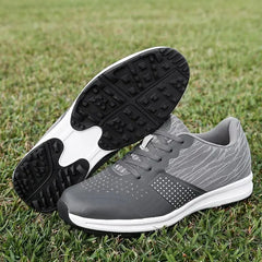 Waterproof men's golf shoes in gray with black soles on grass, designed for comfort and performance.