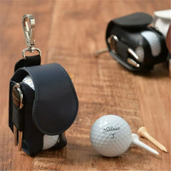 Mini leather golf ball pouch with clip, holding golf balls and tees, displayed on wooden surface for convenience and style.