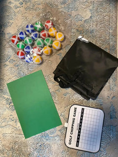 Urban Golf Greens Set with colorful practice balls, carrying case, green mat, and golf chipping game chart on patterned surface.